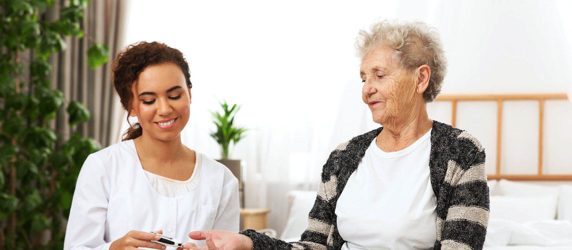 caregiver cutting senior woman's nails