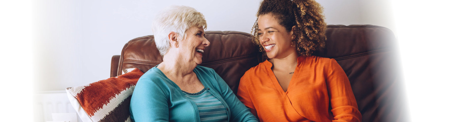 elderly woman and caregiver laughing