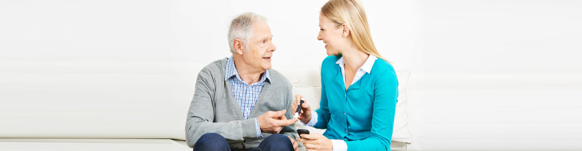 caregiver taking senior man's sugar count