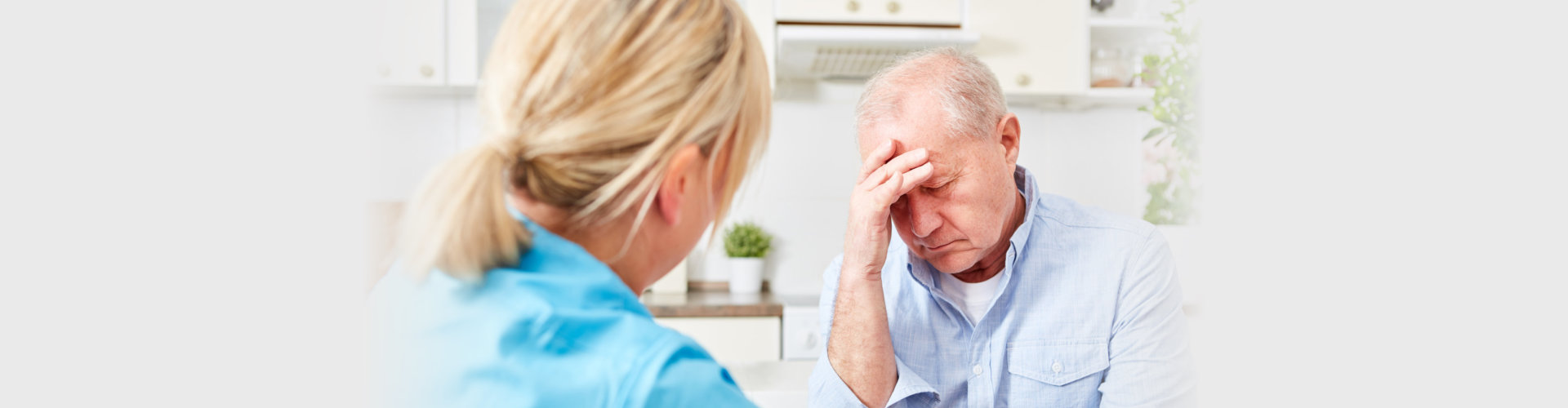 nurse comforts senior man with dementia and depression