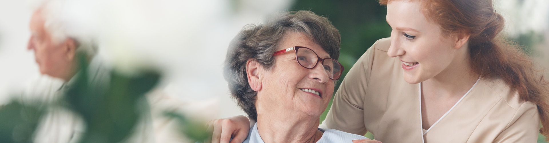 senior woman and caregiver looking at each other